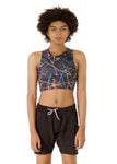 front view of Kali, who has high-sitting A cups, modeling the Active Top in the nearly sold-out Paint Splatter print