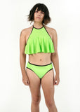 front view of Angel modeling the tucking bikini and ruffle top in green as a set