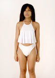 front view of Ravhenna modeling a white Ruffle Top with a cheeky matching midrise gaff